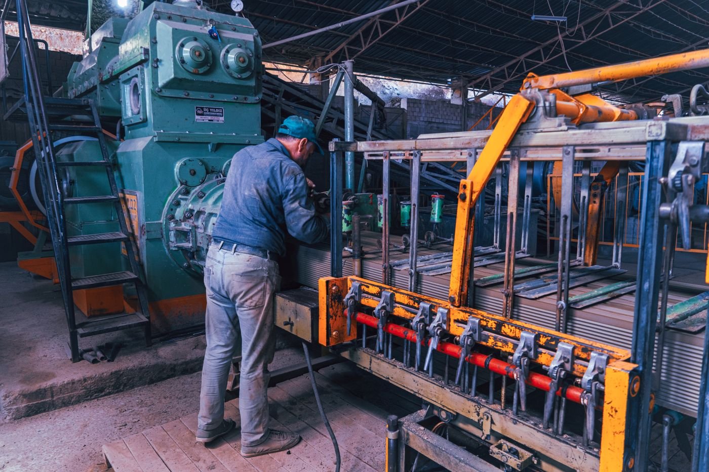 Worker operating machinery in an industrial facility